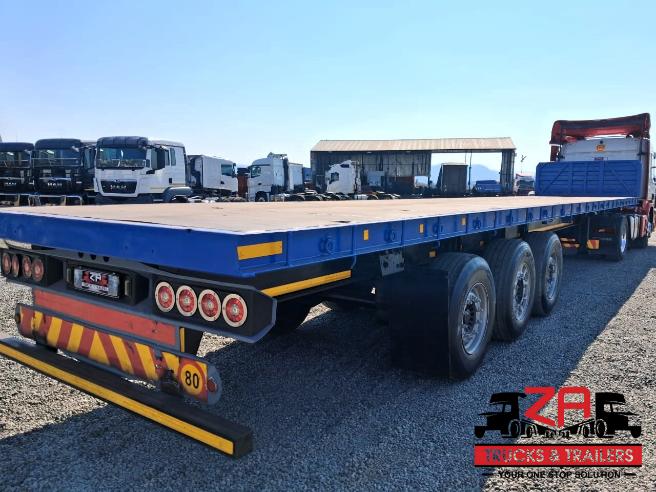 2022 HENRED FREUHAUF TRI-AXLE FLAT DECK TRAILER
