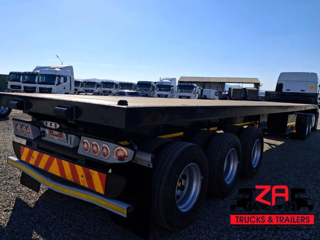 2021 HENRED FRUEHAUF TRI-AXLE FLAT DECK TRAILER